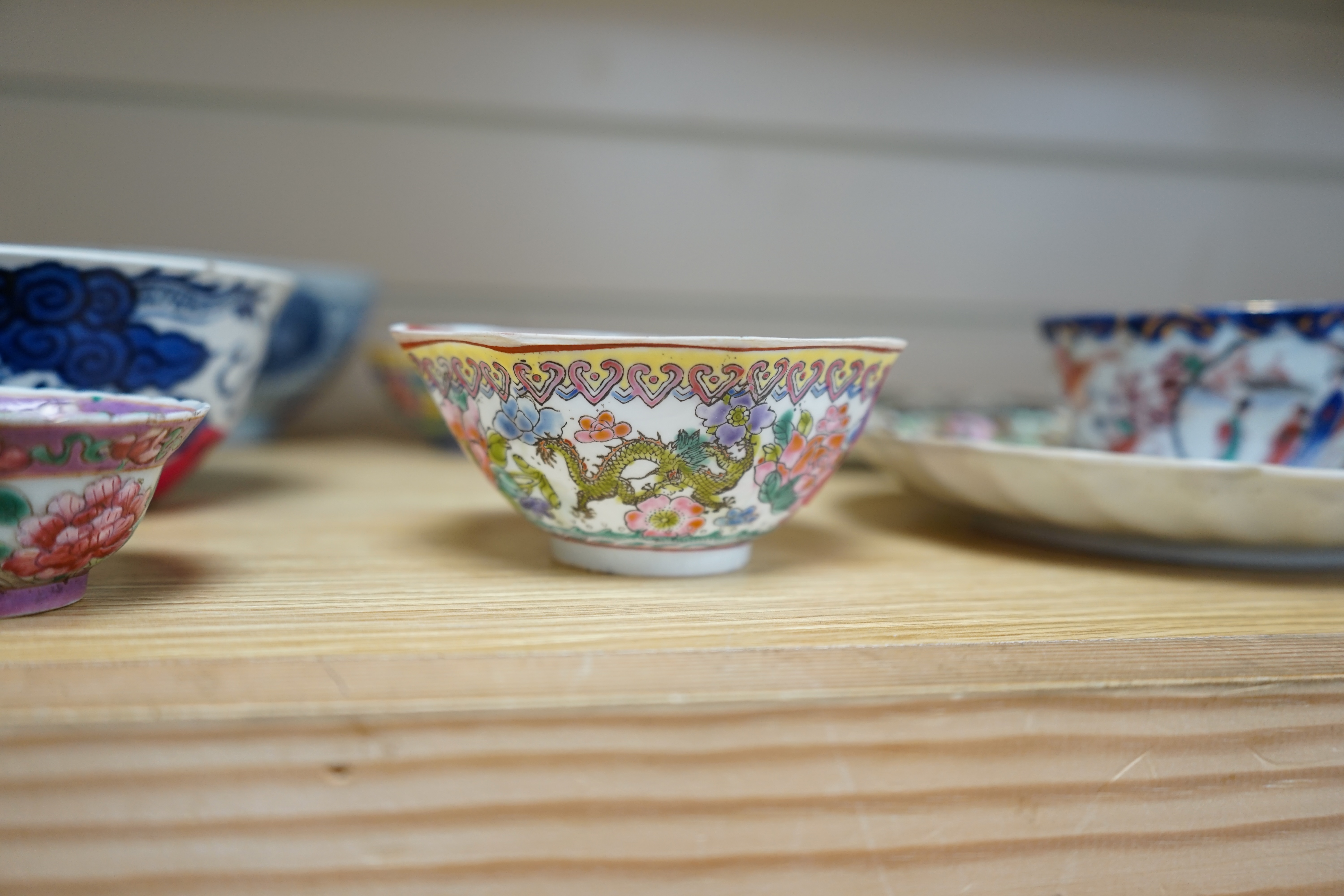 A quantity of Chinese and Japanese porcelain to include blue and white bowls, famille rose tea bowls and a pair of late 19th century dishes (18). Condition - varies, poor to fair